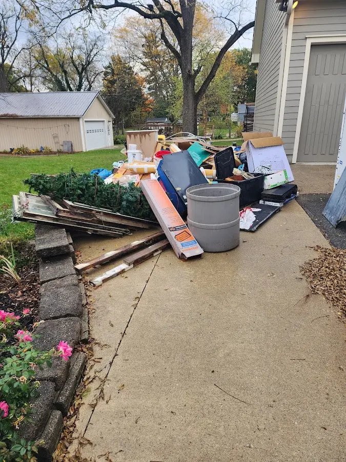 Dumpster being loaded with debris for Estate Cleanout Dumpster Rental in Arcadia